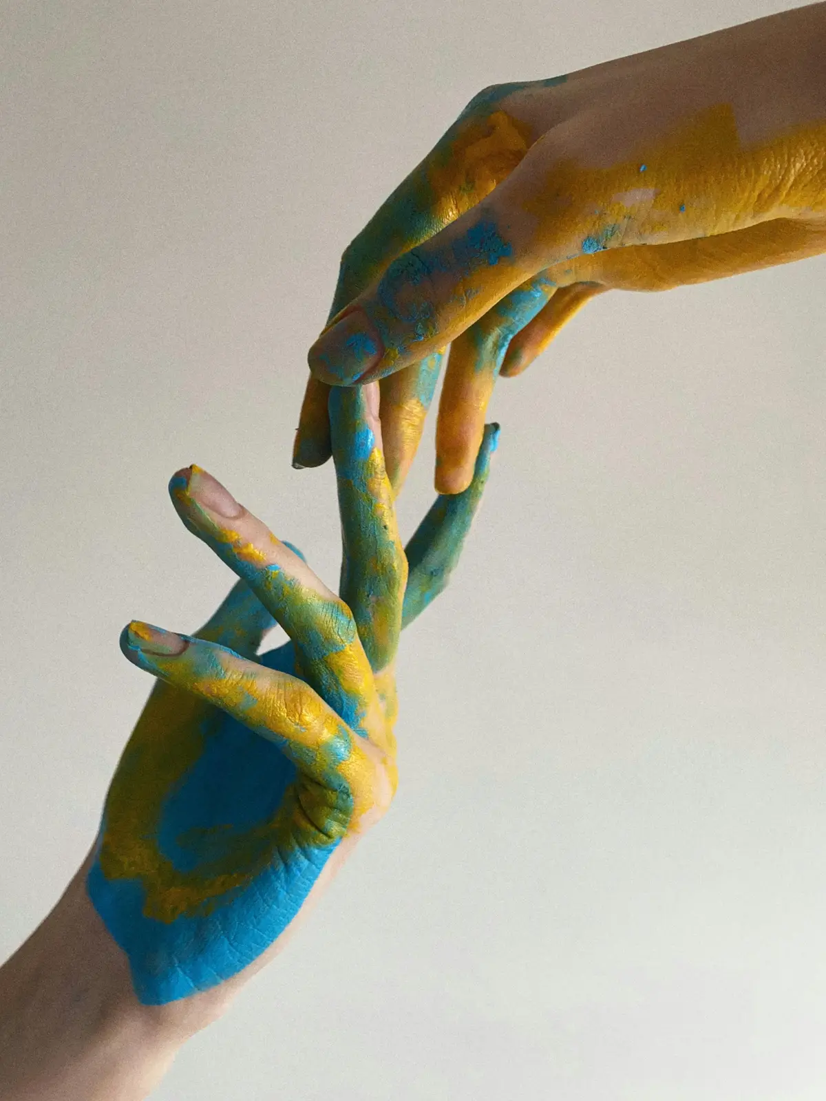 Painted hands reaching toward each other